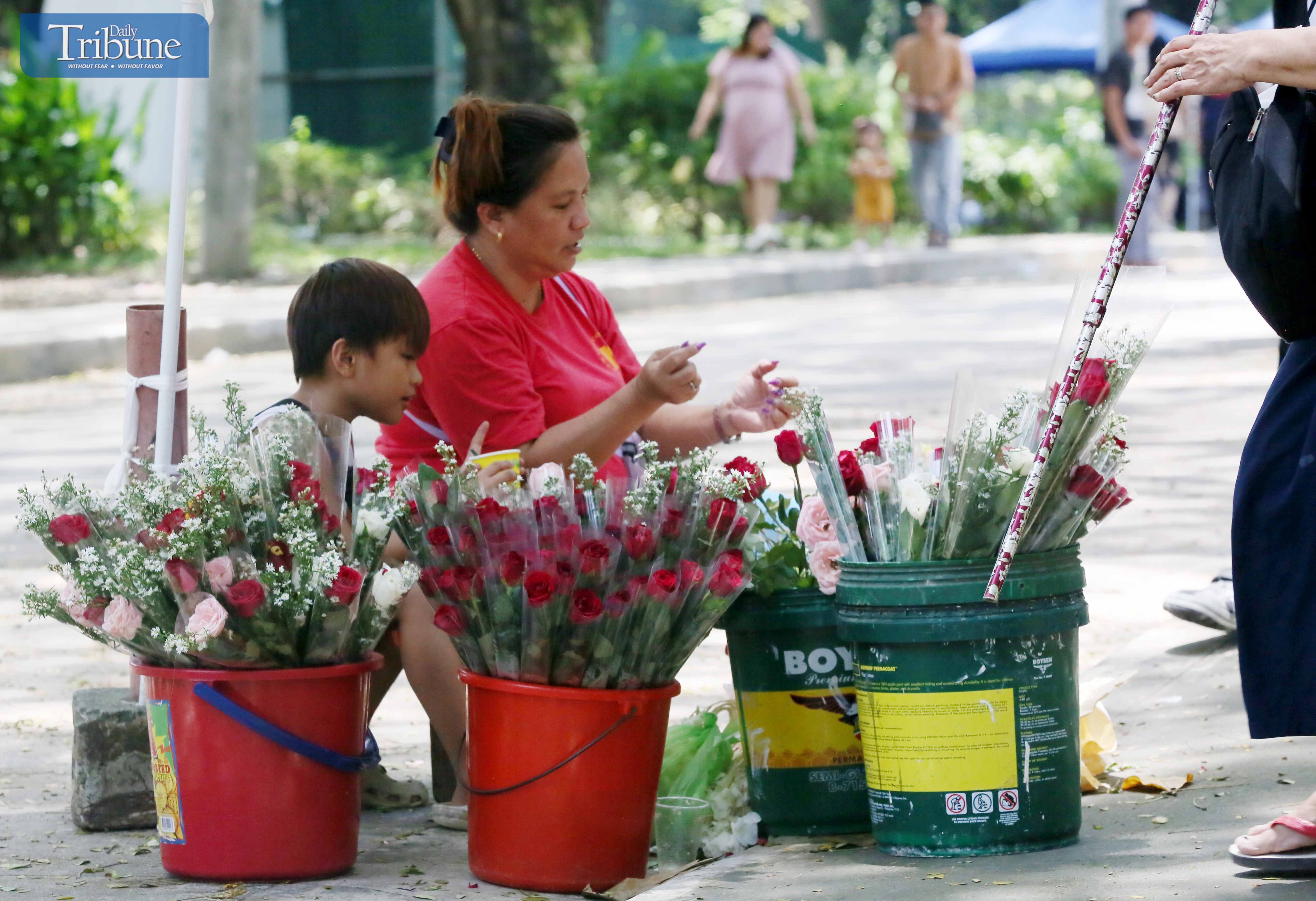 LOOK: A mother and her child sell flowers outside the Parish of the Holy Sacrifice at the University of the Philippines in Diliman, Quezon City on Sunday, 8 September 2024. These flowers are ideal for honoring the Nativity of the Blessed Virgin.